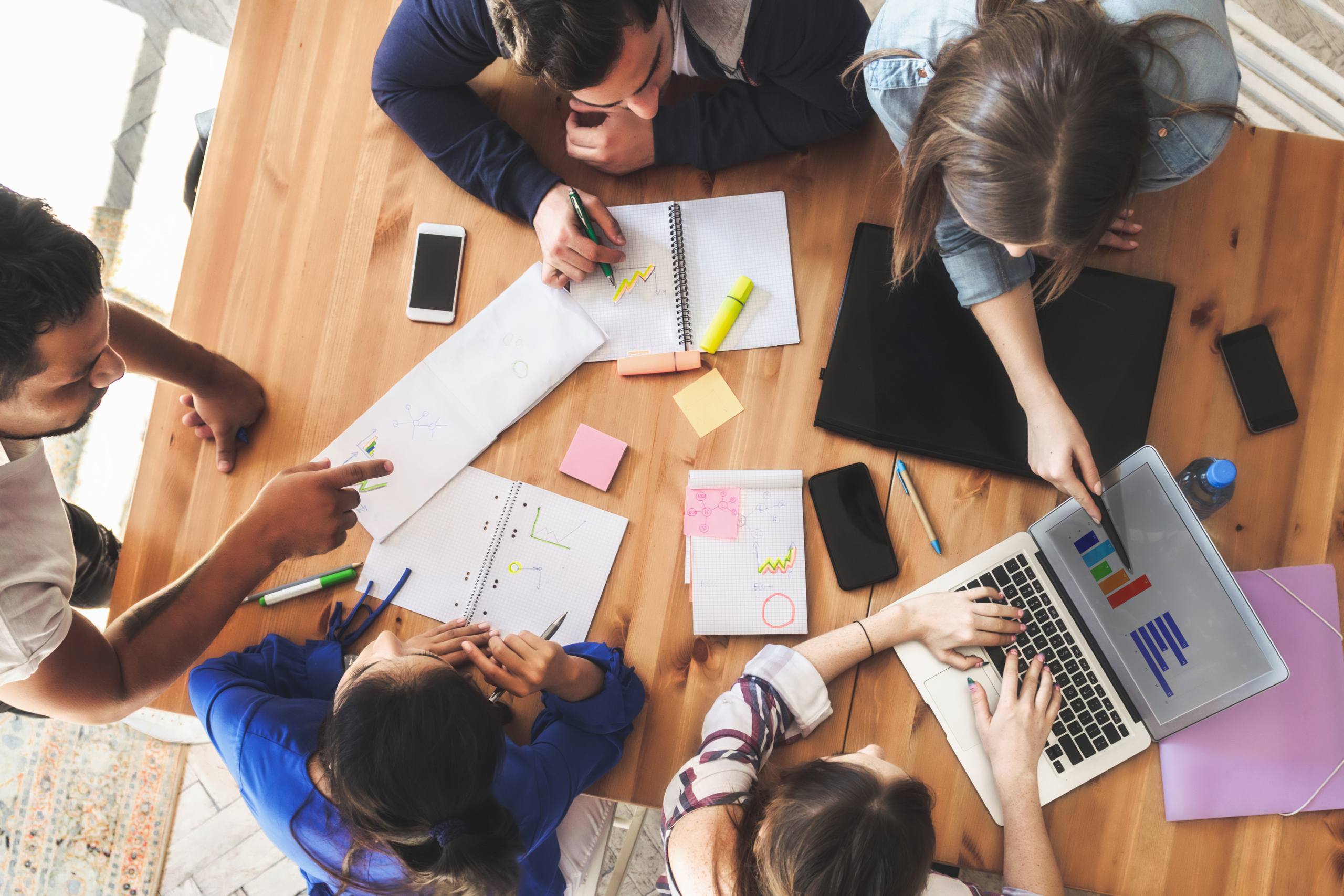 overhead view on business people around desk